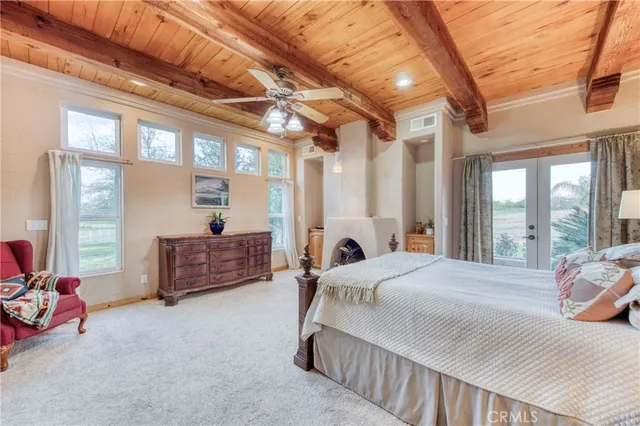 a bedroom with a bed couch and a large window