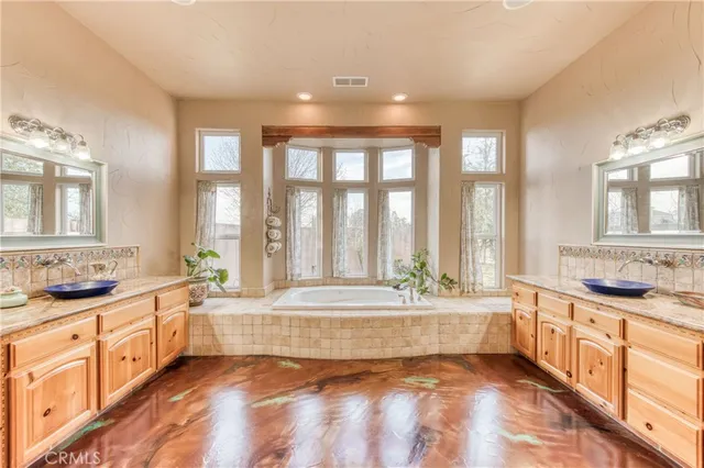 a spacious bathroom with a large tub and sink