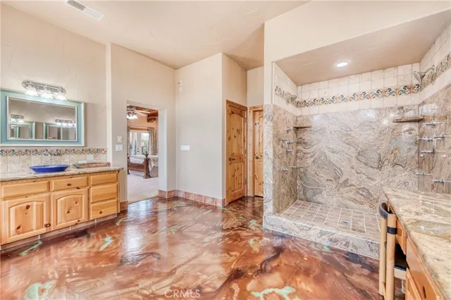 a large bathroom with a granite countertop tub shower sink and mirror