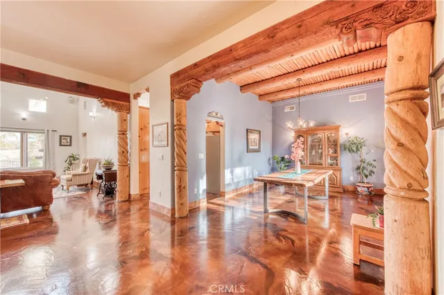 a dining hall with couches a dining table and chairs with outer view