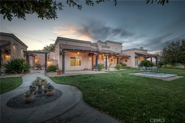a view of a yard with car parked on the road