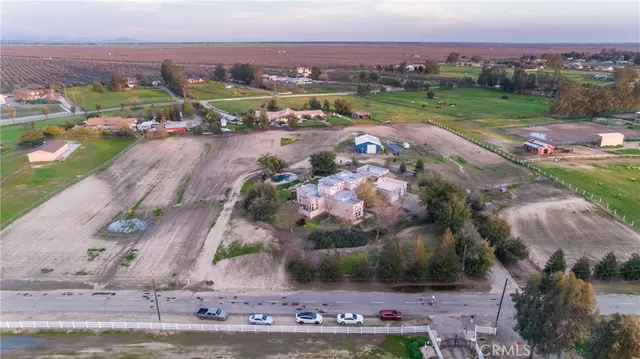 an aerial view of a house with outdoor space and lake view in back