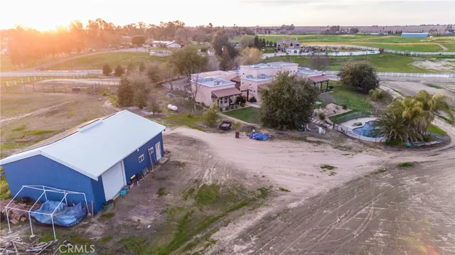 an aerial view of a house with a yard and a fountain
