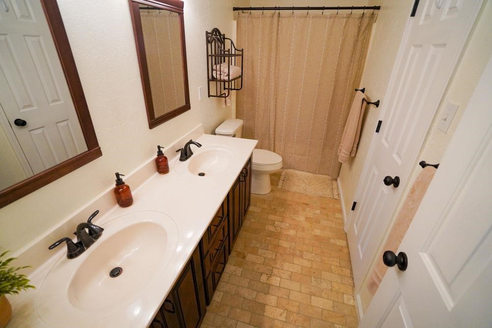 512 Jim McKenzie Road Brighton, TN 38011 - Photo 14 of 20 Dual sinks and beautiful tile flooring help make this bathroom spacious and functional.