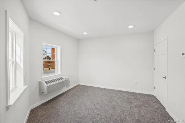 an empty room with a white walls and white walls