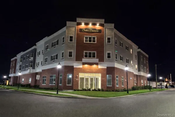 a front view of building with yard and green space