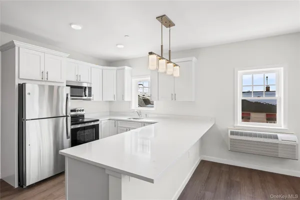 a kitchen with refrigerator cabinets and wooden floor