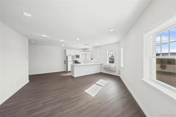 a view of a kitchen with wooden floor and windows