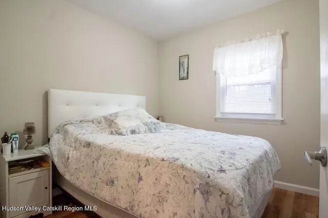 a bedroom with a bed and large windows