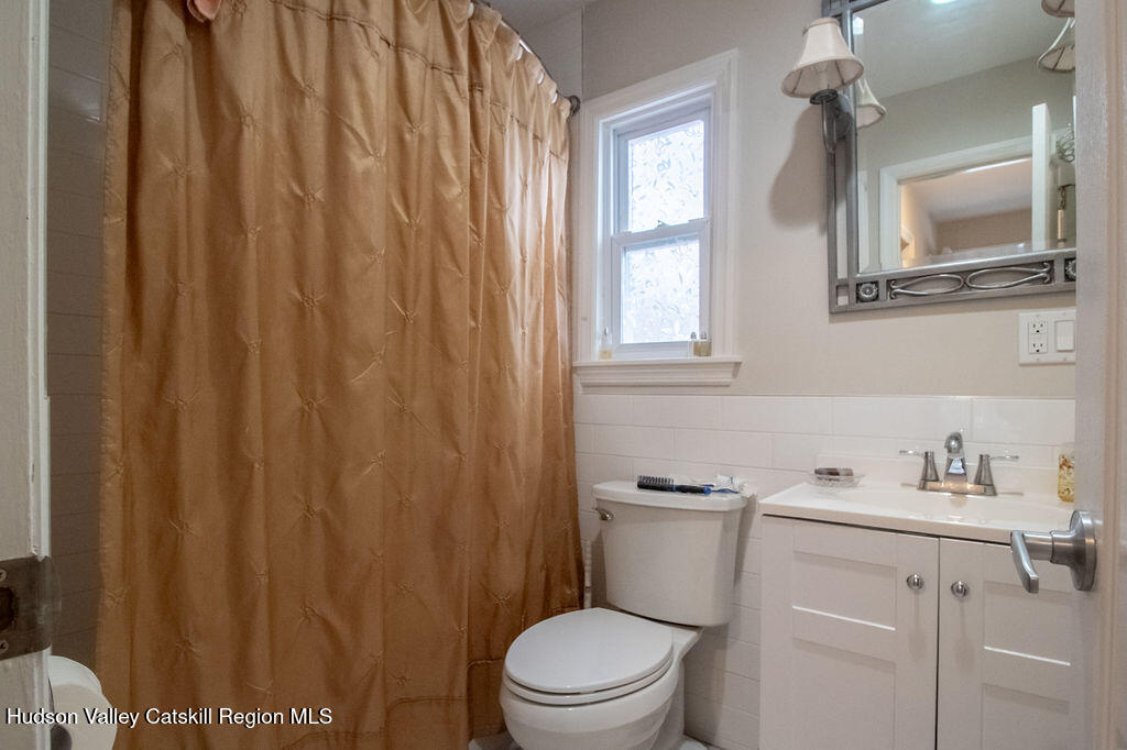 224 Camp Road Ellenville, NY 12428 - Photo 18 of 50 a bathroom with a sink a toilet and shower curtain