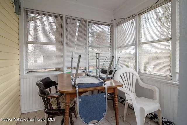 a kitchen with stainless steel appliances a stove a sink a refrigerator white cabinets and wooden floor