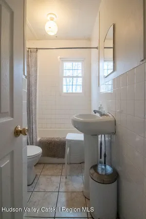 a room with table chairs and a large window