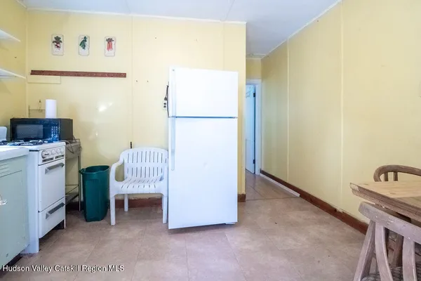 a bedroom with a bed chair and a window