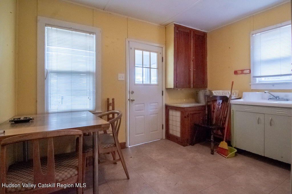 224 Camp Road Ellenville, NY 12428 - Photo 34 of 50 a room with a table chairs and a kitchen view