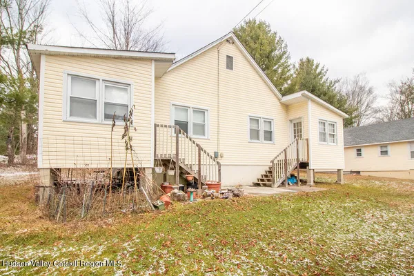 a bathroom with a toilet a sink and shower curtain