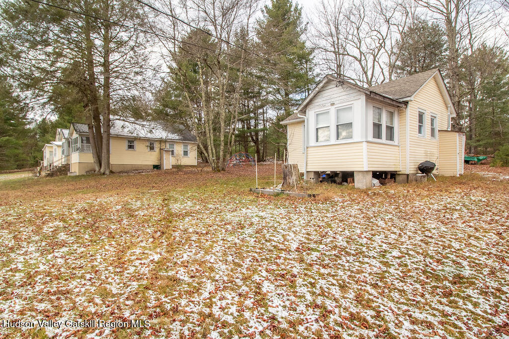 224 Camp Road Ellenville, NY 12428 - Photo 6 of 50 a view of a white house with a yard