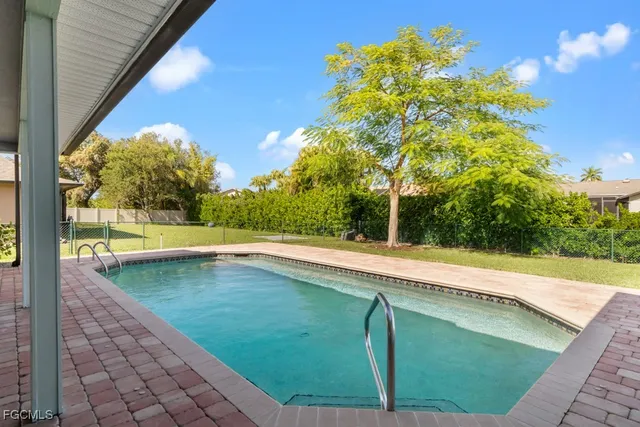 a view of a backyard with table and chairs and potted plants