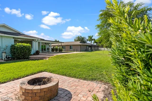 a view of yellow house with a swimming pool