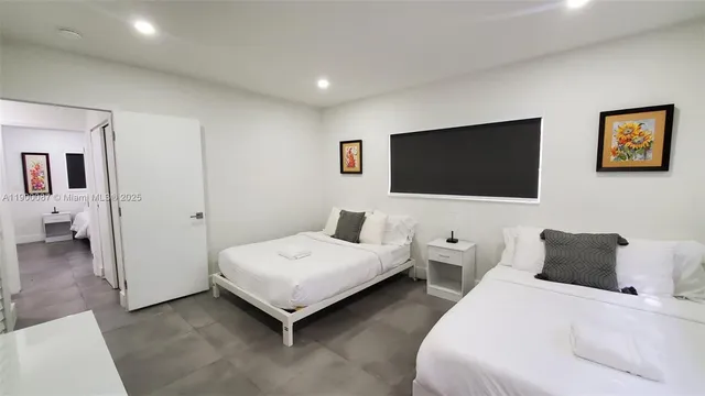 a hotel room with bed and a flat screen tv