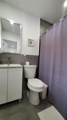 a white toilet sitting next to a bathroom sink
