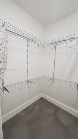 a view of a house with a wooden fence