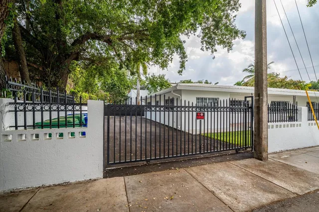a view of a pathway with a wrought fence