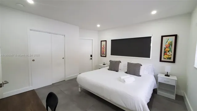 a bedroom with a bed and a flat screen tv