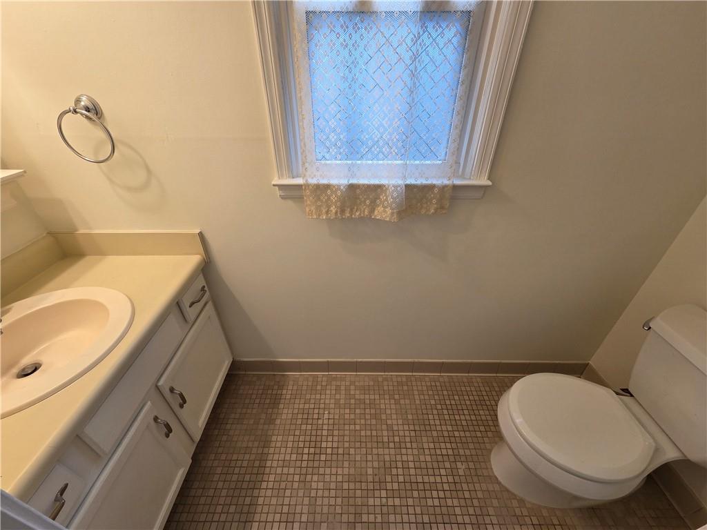 8 Old Decatur Circle Decatur, GA 30030 - Photo 14 of 27 a bathroom with a granite countertop toilet sink and mirror