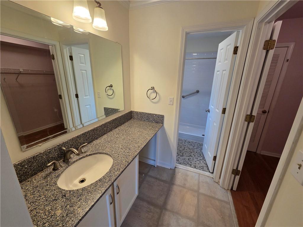 8 Old Decatur Circle Decatur, GA 30030 - Photo 24 of 27 a bathroom with a granite countertop sink a mirror a vanity and a shower