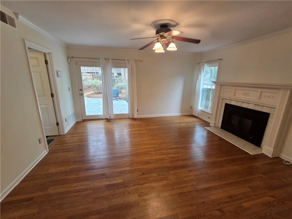 8 Old Decatur Circle Decatur, GA 30030 - Photo 5 of 27 an empty room with wooden floor fireplace and windows