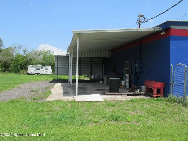 a view of a house with backyard porch and sitting area