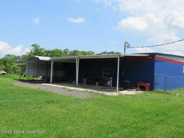 a front view of a house with a yard and sitting area