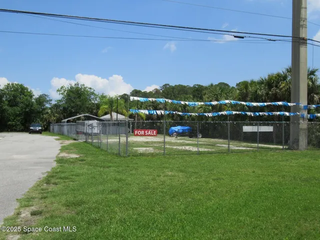 a backyard with table and chairs
