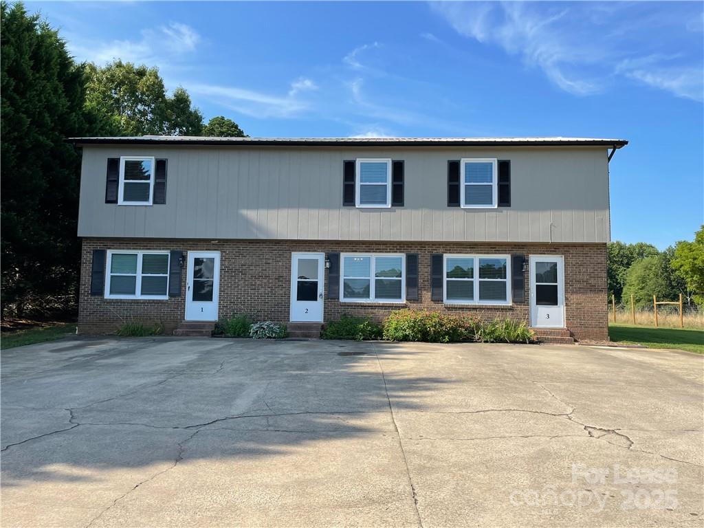 a front view of a house with a yard and a garage