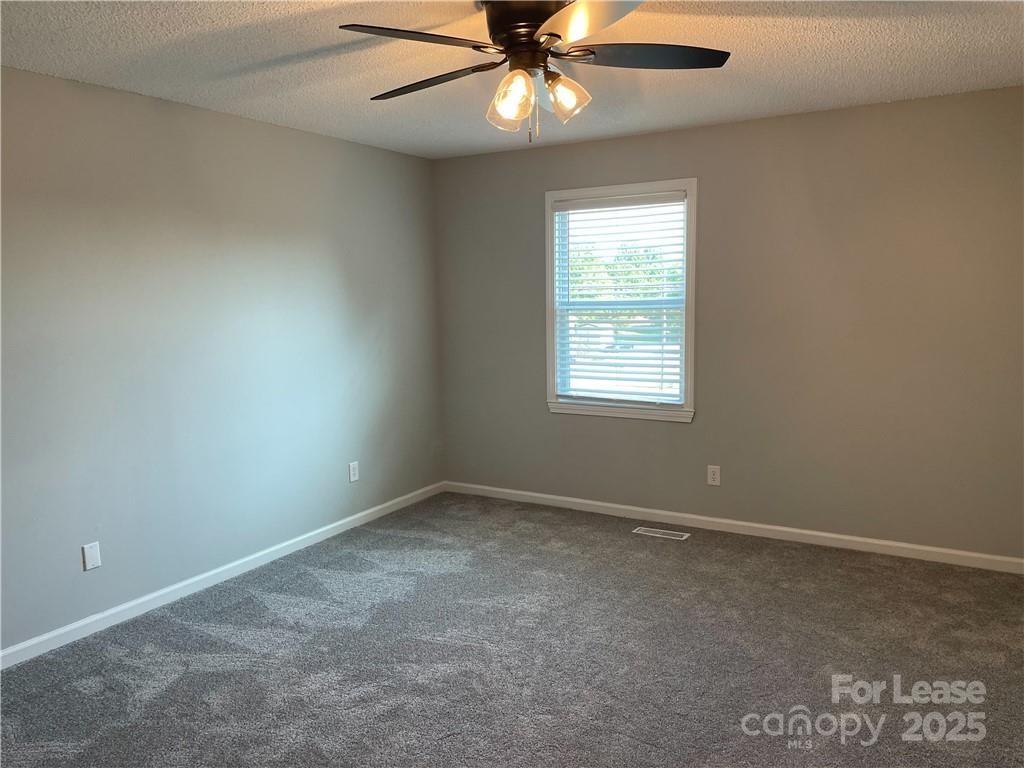 4581 County Home Road, Unit 1 Conover, NC 28613 - Photo 6 of 10 an empty room with a window and a fan