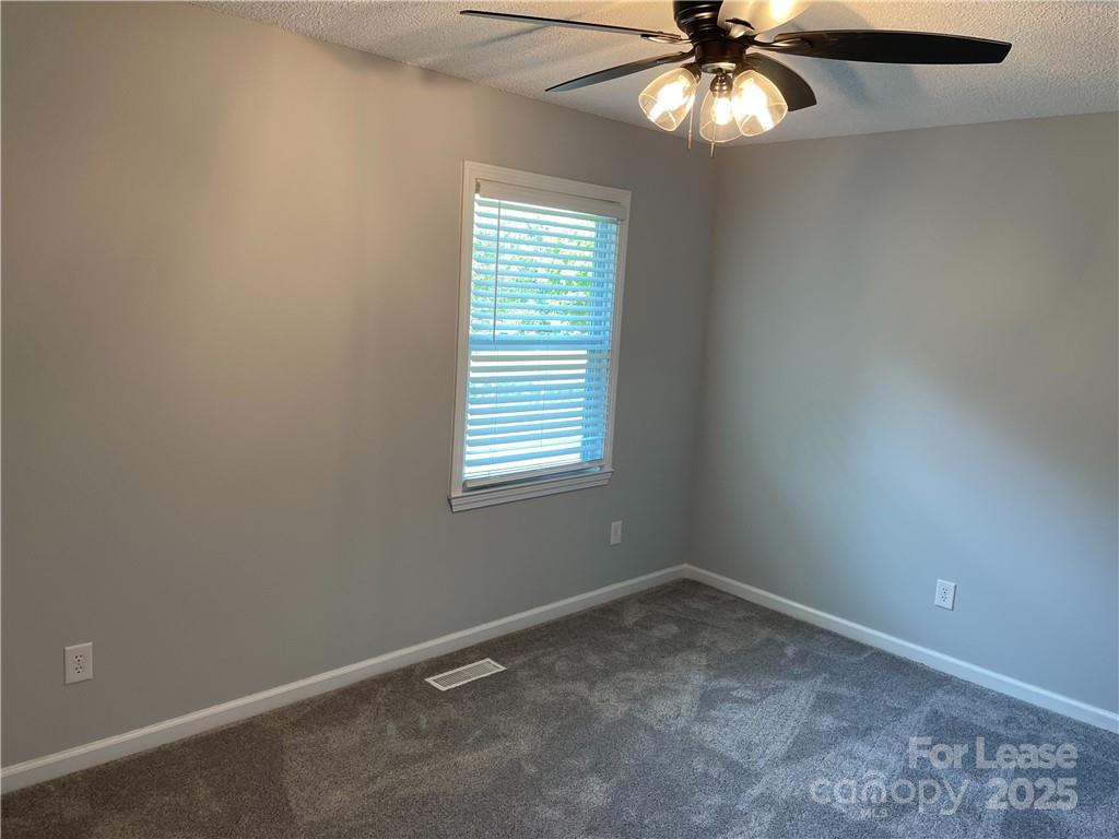 4581 County Home Road, Unit 1 Conover, NC 28613 - Photo 7 of 10 an empty room with a window and a fan