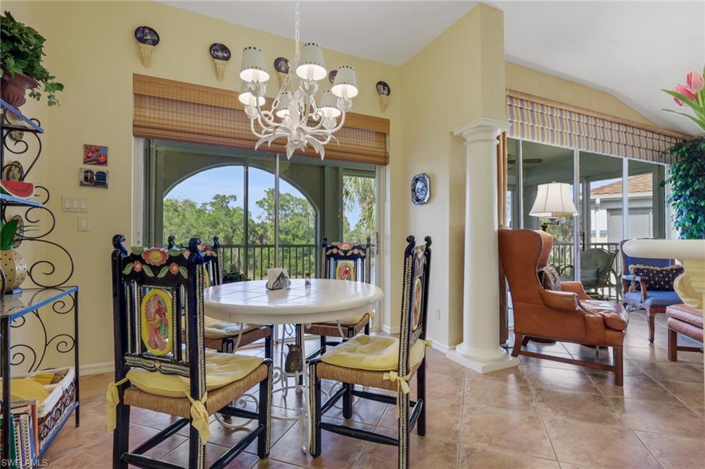 10801 Crooked River Road, Unit 203 Estero, FL 34135 - Photo 10 of 27 a view of a dining room with furniture a chandelier and wooden floor