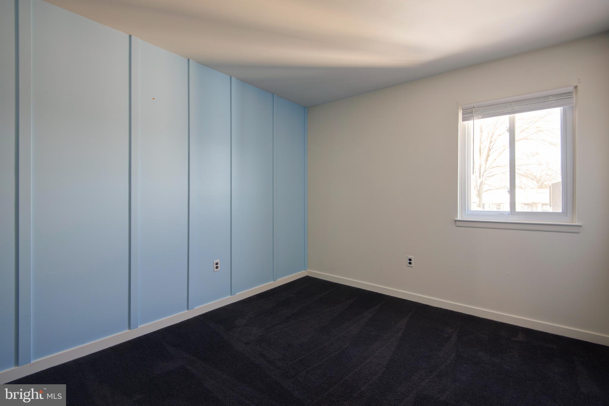 1210 Painters Crossing, Unit 1210 Chadds Ford, PA 19317 - Photo 12 of 18 an empty room with wooden floor and closet area
