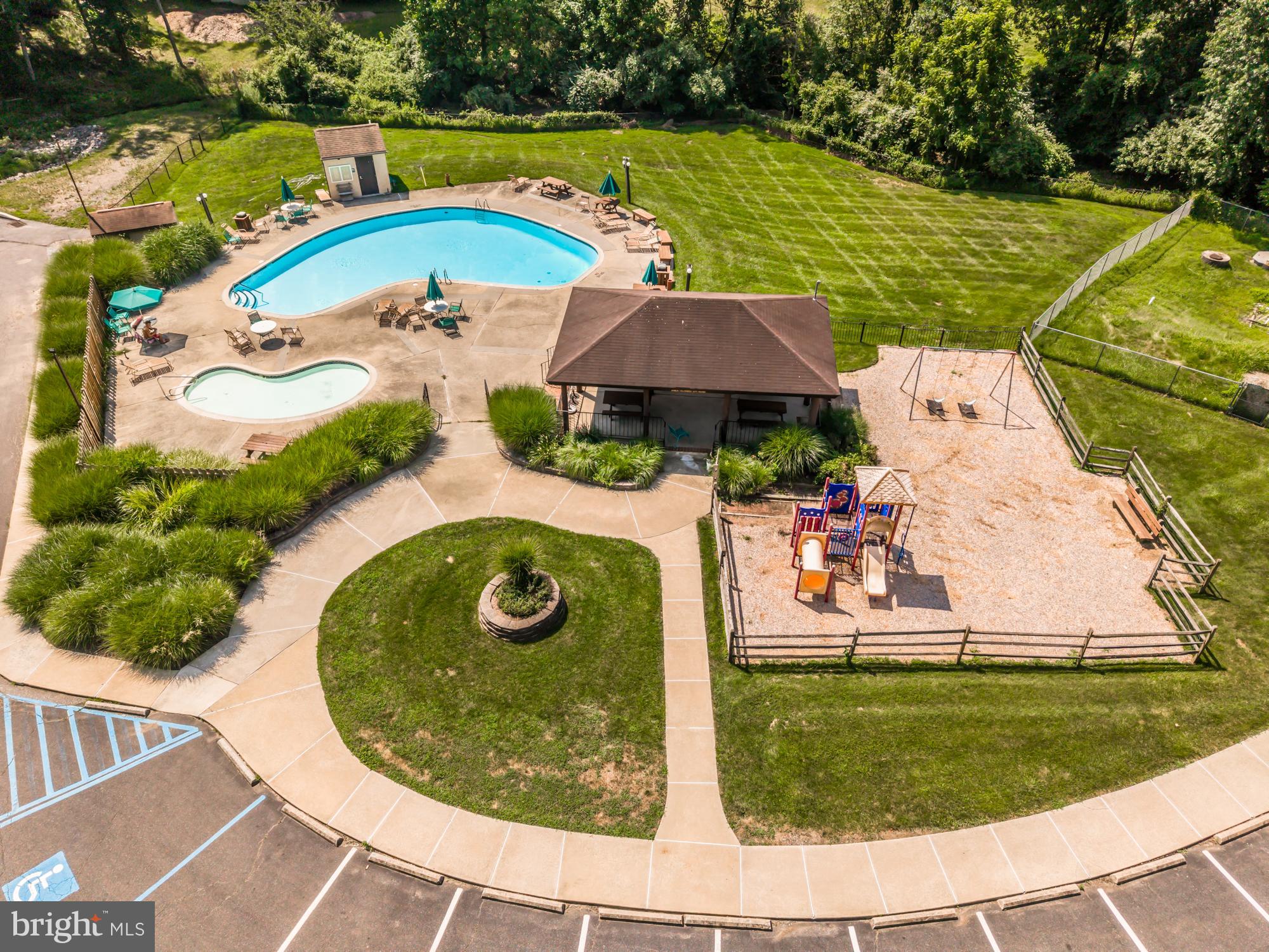 1210 Painters Crossing, Unit 1210 Chadds Ford, PA 19317 - Photo 17 of 18 an aerial view of a house with outdoor space and swimming pool