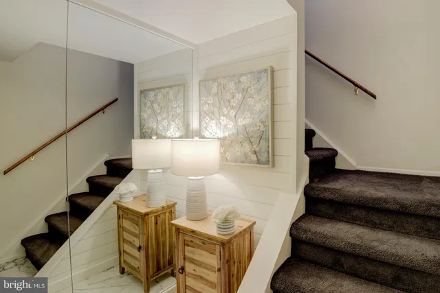 a living room with furniture and stairs