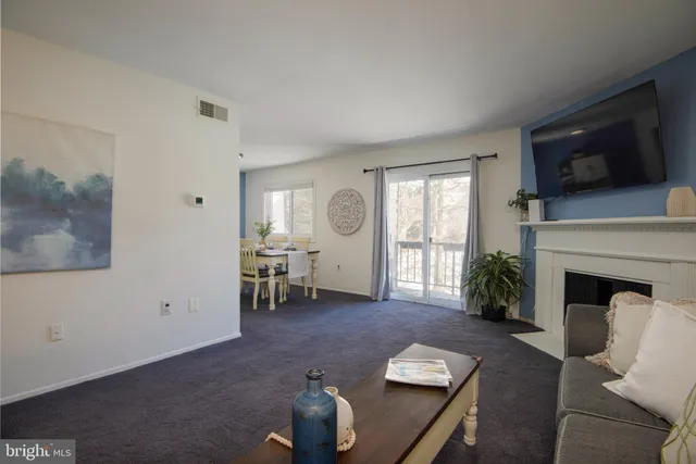 a living room with furniture fireplace and flat screen tv