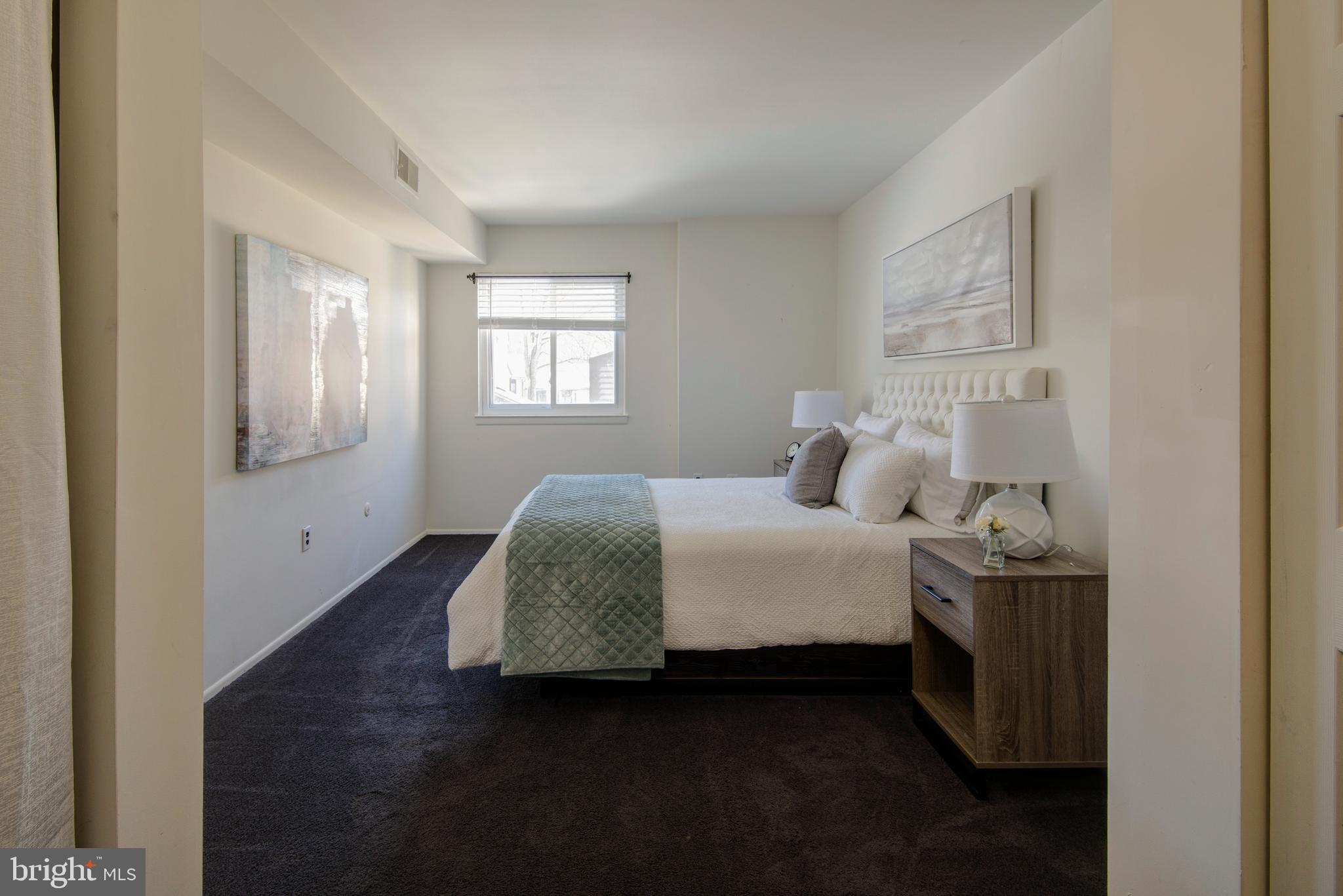 1210 Painters Crossing, Unit 1210 Chadds Ford, PA 19317 - Photo 9 of 18 a bedroom with a bed and window