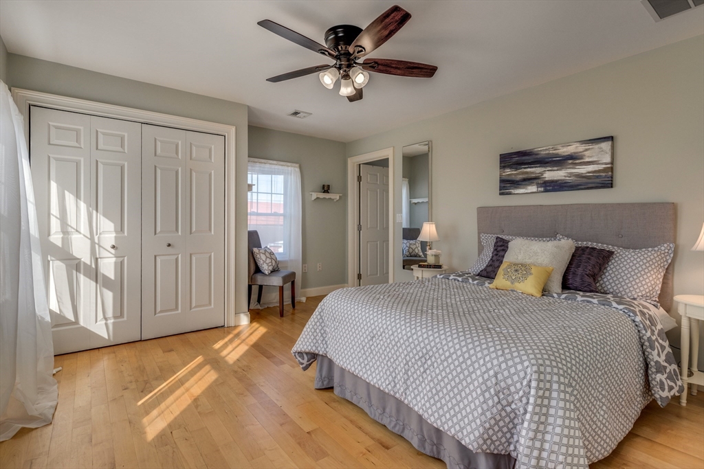 2 Melvin Street, Unit 2 Wakefield, MA 01880 - Photo 11 of 17 a bedroom with a bed and a chandelier