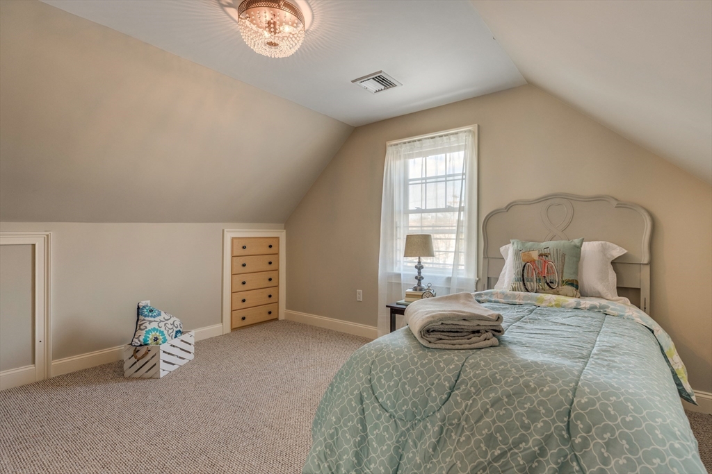 2 Melvin Street, Unit 2 Wakefield, MA 01880 - Photo 13 of 17 a bedroom with a bed and a window