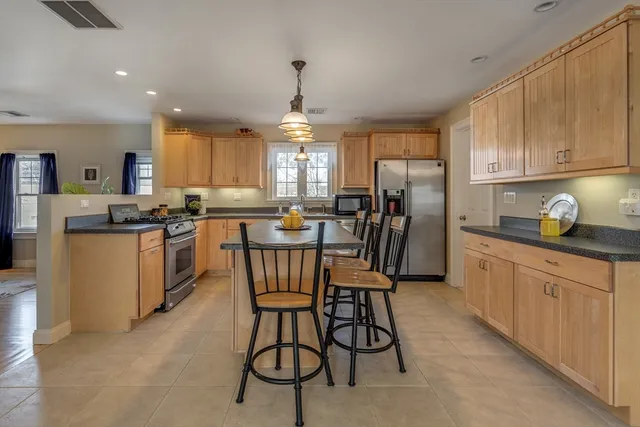a kitchen that has a lot of cabinets in it and appliances