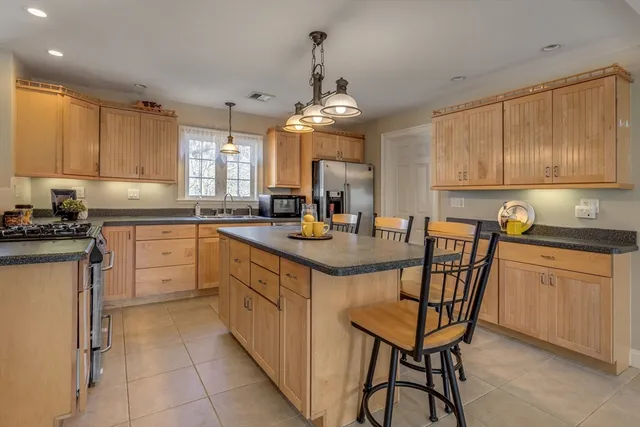 a kitchen with a sink window and cabinets