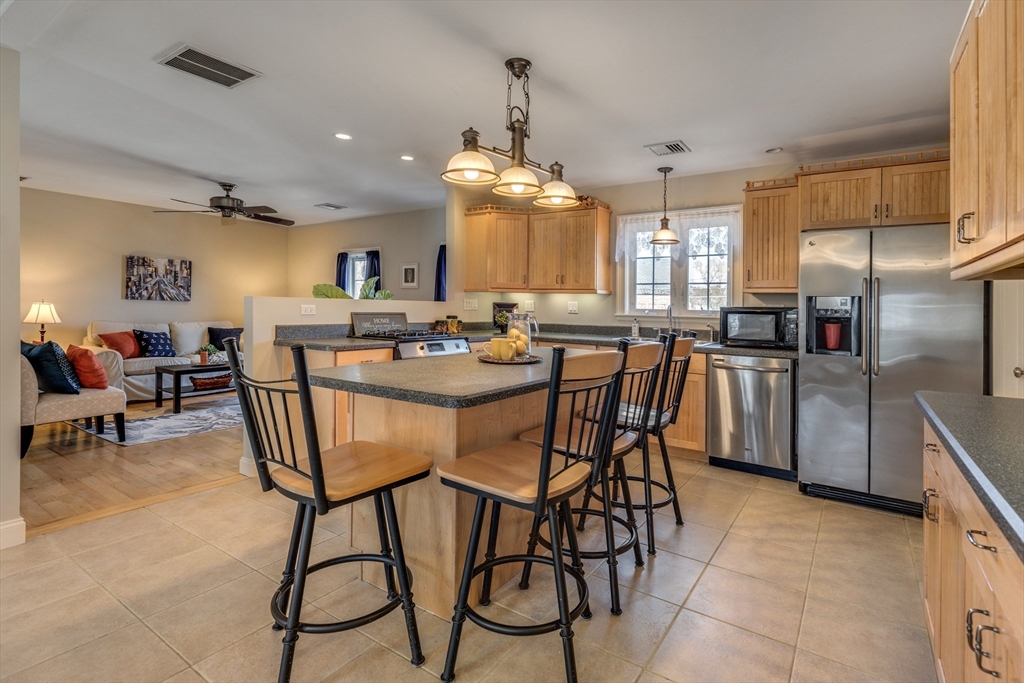 2 Melvin Street, Unit 2 Wakefield, MA 01880 - Photo 4 of 17 a view of a dining room with furniture and a chandelier