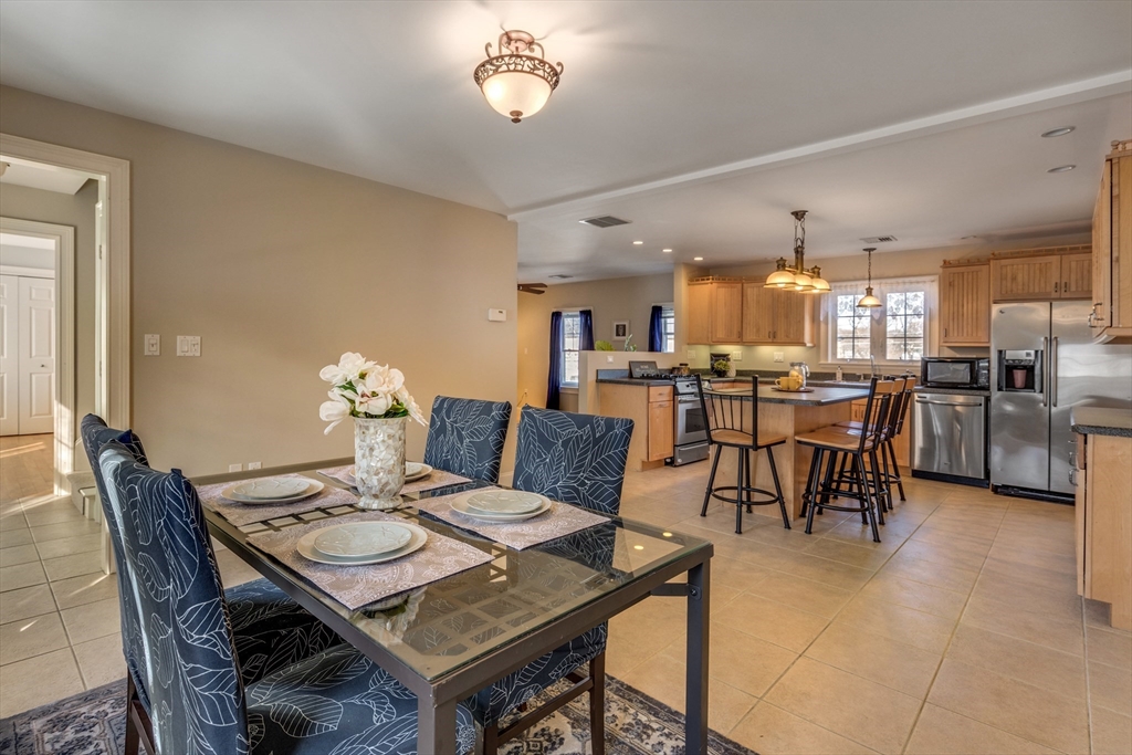 2 Melvin Street, Unit 2 Wakefield, MA 01880 - Photo 8 of 17 a view of a dining room with furniture and a large window