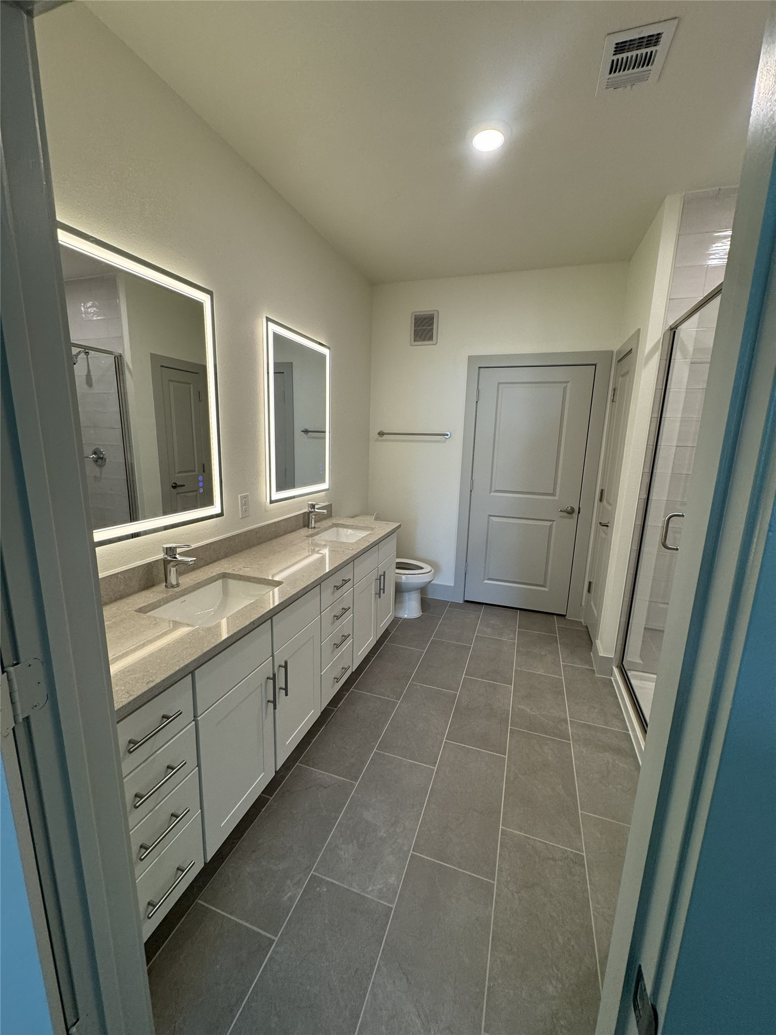 26244 Twin Oaks Road Splendora, TX 77372 - Photo 4 of 10 a bathroom with a double vanity sink and a mirror