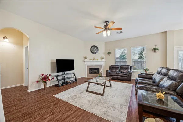 a living room with furniture a fireplace and a flat screen tv